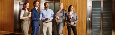 Diverse business team waits in front of elevator. clipart