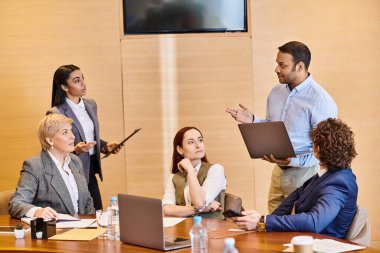 Diverse professionals discuss ideas around a conference table. clipart