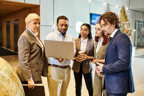 stock image Diverse business team discussing on laptop screen.