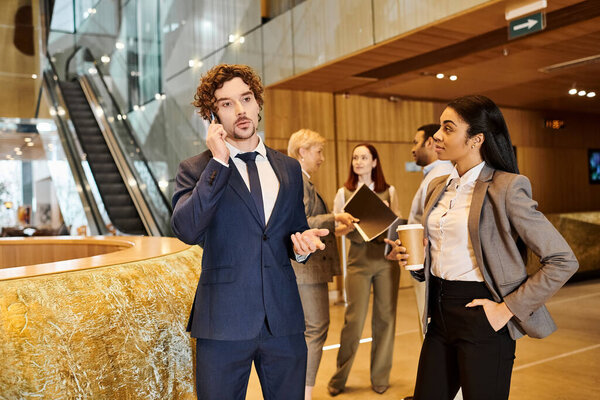 A multicultural businessman in a sharp suit conversing on a cellphone.