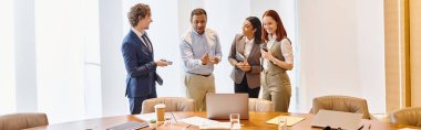 Multicultural business professionals discussing strategy at a wooden table. clipart