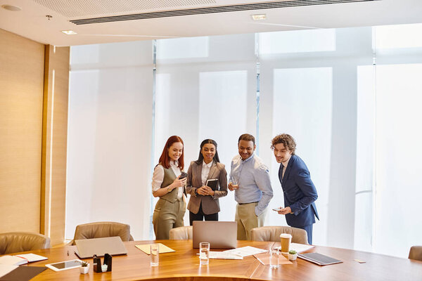 A diverse group of business professionals discussing ideas around a conference table.