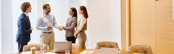 stock image Multicultural business team discussing strategies around a conference table.