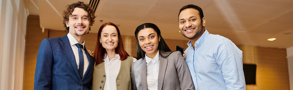 An interracial group of business people standing together.