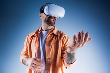 A man wearing a virtual headset while immersed in the metaverse in a studio setting. clipart