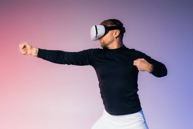 A man in a black shirt stands blindfolded, immersing himself in unknown realms through his virtual reality headset in a studio setting. clipart