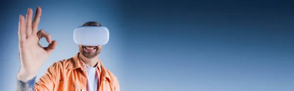 Man Orange Shirt Wearing Blindfold Poses Studio Setting Virtual Reality — Stock Photo, Image