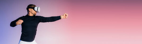 A man in a black shirt and white pants plays a game in a studio setting.