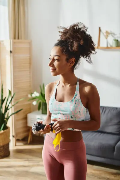 stock image A stylish woman captures the essence of her living room with a camera in hand.