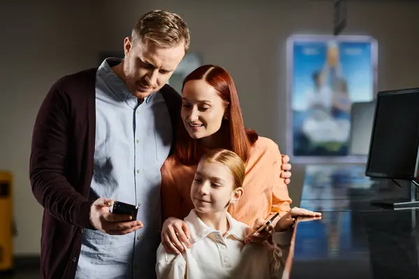 stock image A man and two women, a happy family, stand together at the cinema, enjoying a day out.