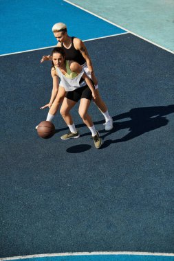 women enjoy a friendly game of basketball on an outdoor court under the summer sun. clipart