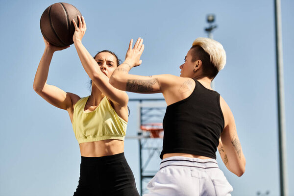 Two young women standing side by side, energetically holding a basketball, enjoying a sporty moment outdoors in the summer.