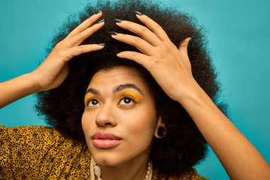 Afro-Amerikalı kadın saçlarını yüzünün önünde tutuyor..