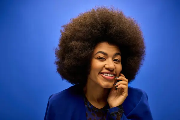 stock image Trendy African American woman with curly hairdo talking on cell phone.