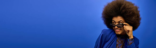 Stylish man with curly hairdocapturing a moment with camera.