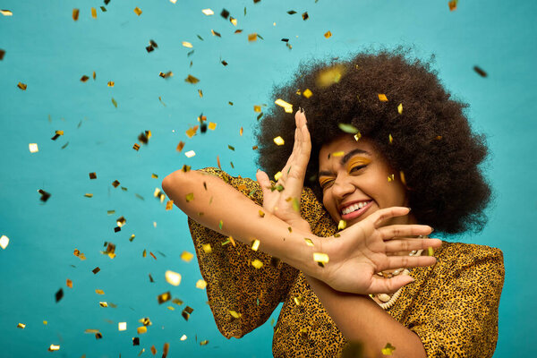 Stylish African American woman with curly hairdoholding hand to face in confidence.