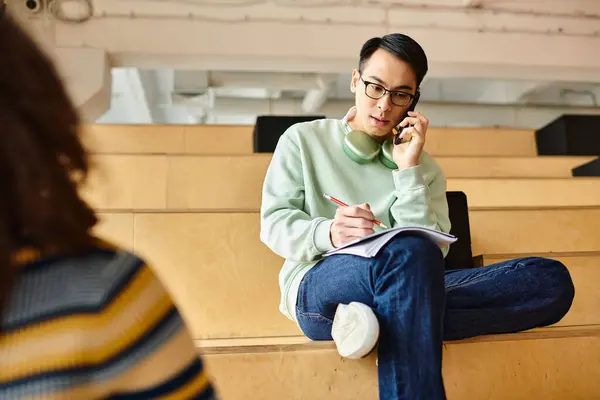 Stock image A multicultural African American woman sitting on a bench, engrossed in a conversation on her cell phone.