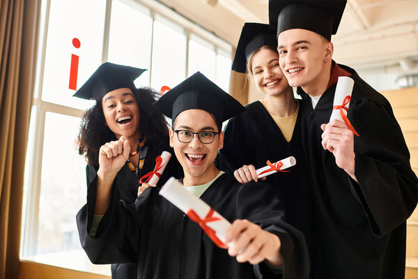 A diverse group of students in graduation gowns and caps joyfully posing for a picture to commemorate their academic success.