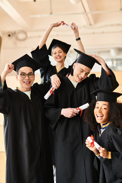 Group of multicultural university students in graduation gowns and caps posing happily for a commemorative moment.