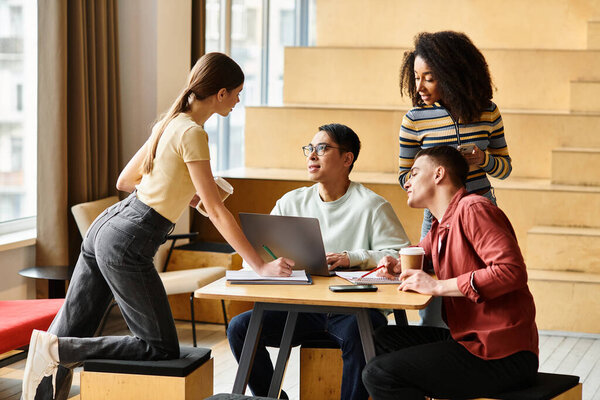 A diverse group of students from different backgrounds conversing and studying at a wooden table indoors.