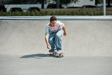 A young skater boy fearlessly rides his skateboard down the ramp in a vibrant outdoor skate park on a sunny summer day. clipart