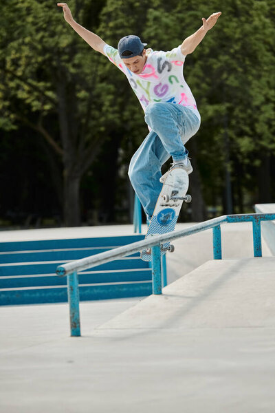 A young skater boy confidently rides his skateboard down the side of a rail at a bustling urban skate park on a sunny summer day.