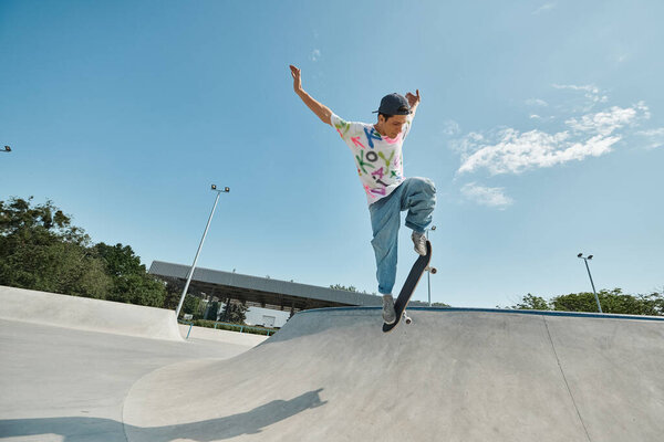 A young skater boy propels himself up a skateboard ramp at an outdoor skate park on a sunny summer day.