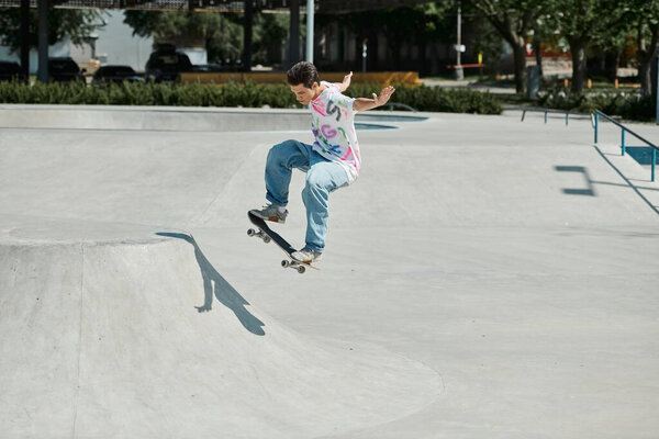 A young man courageously rides his skateboard up the steep side of a ramp at a skate park on a sunny summer day.