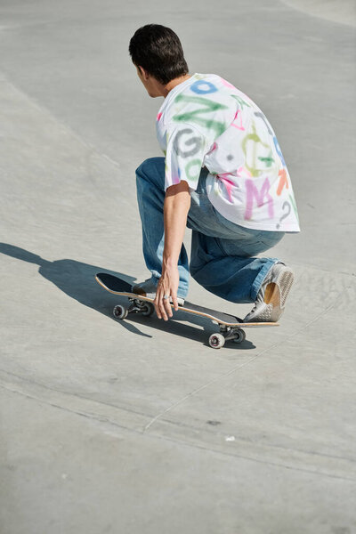 A young skater boy enjoys riding his skateboard down a steep cement ramp at an outdoor skate park on a sunny summer day.