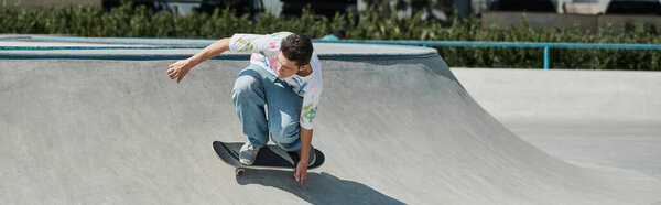 A young skater boy riding a skateboard up the side of a ramp at a skate park on a summer day.