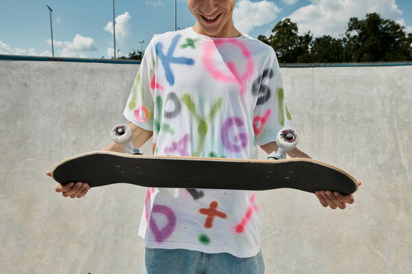 A young man with a skateboard in a vibrant skate park, capturing the essence of freedom and adrenaline while skating outdoors in the summer.