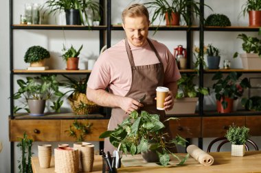 A charismatic man in an apron enjoys a cup of coffee in his plant shop, embodying the essence of entrepreneurship. clipart