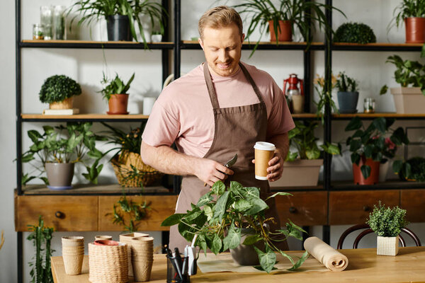 A charismatic man in an apron enjoys a cup of coffee in his plant shop, embodying the essence of entrepreneurship.