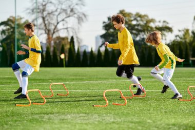 A lively group of young children joyfully engage in a spirited game of soccer, running, kicking, and passing the ball on a grassy field. Their faces show excitement and determination as they compete in friendly yet competitive spirit. clipart