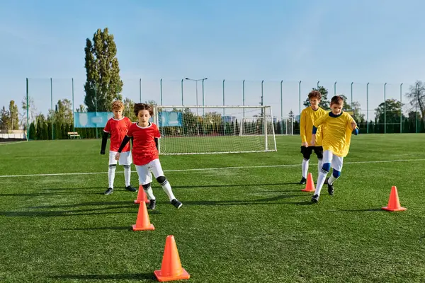 A group of young boys enthusiastically playing soccer on a green field. They are dribbling, passing, and shooting the ball with excitement and joy.