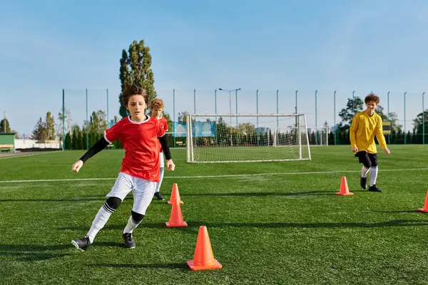 A dynamic scene unfolds as a group of young people engage in an intense game of soccer, displaying impressive teamwork, skillful ball handling, and competitive spirit on the field.