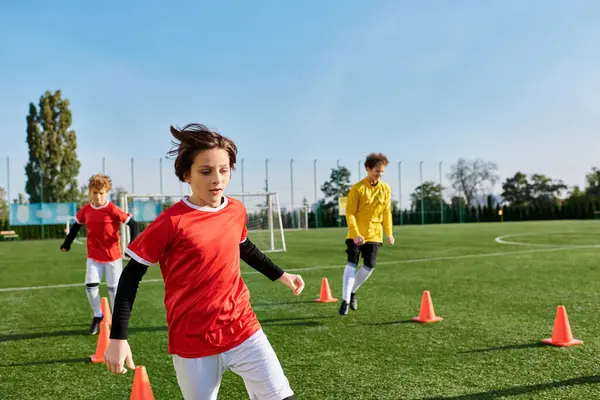 A dynamic scene unfolds as a group of young people engage in an intense game of soccer, showcasing their skills and teamwork on the field.