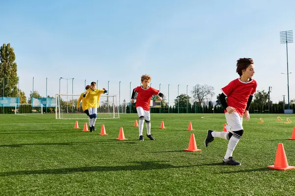 A group of young boys are enthusiastically playing soccer on a lush green field. They are running, kicking, and passing the ball while displaying teamwork and sportsmanship.