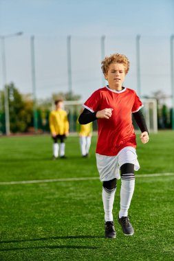 A young boy is joyfully sprinting across a lush green soccer field, with the focus on his agile movement and enthusiasm for the game. clipart