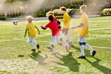 A vibrant scene unfolds as a group of energetic children engage in a spirited game of soccer on a sunny field, kicking, dribbling, and passing the ball with enthusiasm and teamwork. clipart