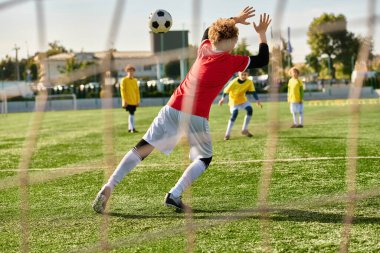 A dynamic scene unfolds as a group of young men compete fiercely in a game of soccer, sprinting, passing, and shooting towards the goal with undeniable passion and skill. clipart