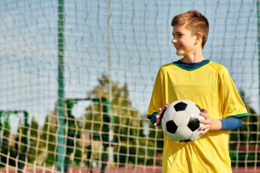 A young boy stands confidently in front of a goal, soccer ball in hand, envisioning his victory. His gaze is fixed on the net, determination in his eyes. clipart
