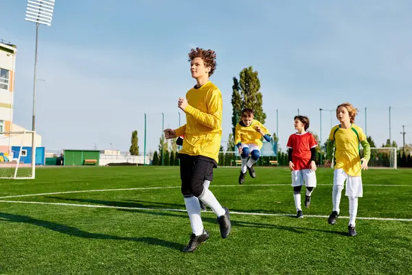 A dynamic scene unfolds as a group of energetic young individuals engage in a spirited game of soccer, showcasing skill, teamwork, and enthusiasm on the field.