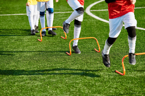 A group of young men stands confidently at the peak of a soccer field, looking out over the vast expanse of the pitch. The sense of achievement is palpable as they celebrate their victory.