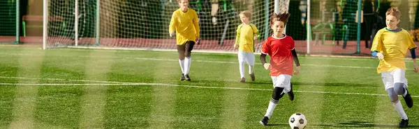 A lively group of young men engaged in an intense game of soccer, kicking the ball around the field with skill and determination, displaying teamwork and competitive spirit.