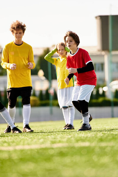 A dynamic group of young people triumphantly stands on the top of a soccer field, exuding energy and teamwork as they celebrate their victory.