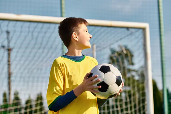 Young Boy Stands Front Soccer Goal Holding Soccer Ball Gazes — Stock Photo, Image