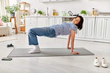 Young girl gracefully practices yoga on mat. clipart