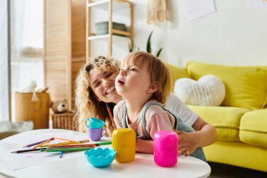 A curly-haired mother and her toddler daughter happily playing with toys in their cozy living room. clipart