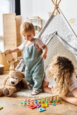 girl play enthusiastically with a wooden car, fostering creativity and imagination through play. clipart